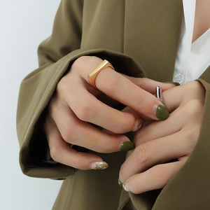 Minimalist rectangular gold ring and silver band set in modern stacked style