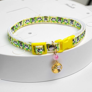 Detail of adjustable pet collar featuring cute panda and bamboo prints with a gold pendant