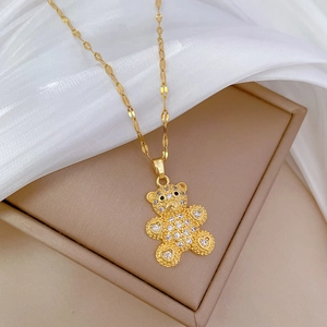 Luxurious gold bear pendant necklace with cubic zirconia on elegant silk background