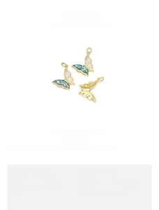 Detail view of butterfly pendant with 18K gold plating and emerald opal wings