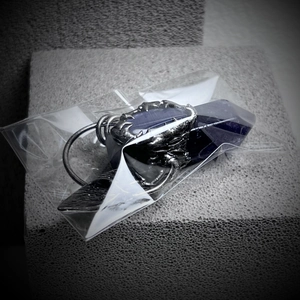 Detailed view of amethyst hexagonal pendant held by antique silver claw setting