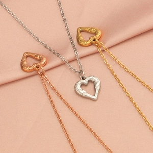 Three minimalist stainless steel necklaces in gold, silver and rose gold with heart pendants