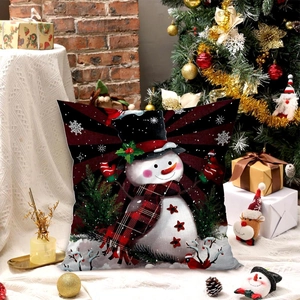 Christmas snowman pillow cover on festive background with tree and holiday lights