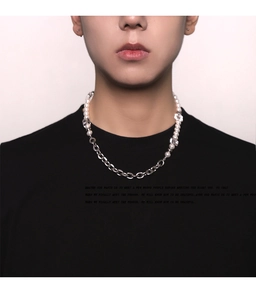 Close-up of pearl and silver link chain necklace worn on a black casual shirt