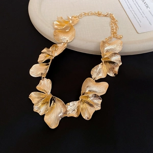 Detailed macro shot of large golden textured flower pendant with brushed metal finish