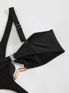 Detail of black bikini with golden wavy metal hardware and adjustable thin strap
