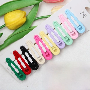 Set of 10 colorful wavy drop hair clips on white cardstock with floral background