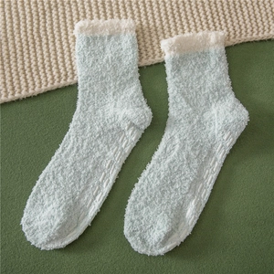 Detail of coral fleece non-slip socks with silicone grips and warm mint green texture