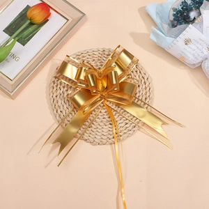 Macro view of a large gold matte metallic organza bow for Christmas gift wrapping and decor