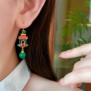 Detail of Chinese style 18K gold heart earring with colorful enamel lantern design