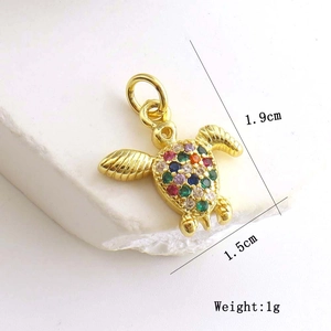 Detailed view of turtle pendant with colorful zircon stones measuring 1.9cm by 1.5cm