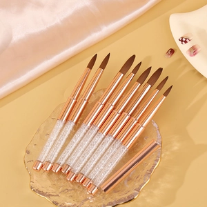 Crystal handle nail art brush set with gold metal accents on silk and glass tray