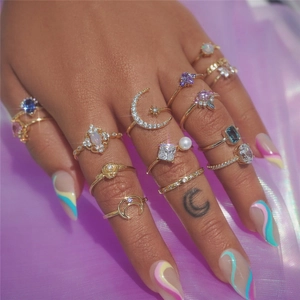 Close-up of S925 silver gold rings with colorful crystals and flower motifs on hand