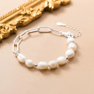 Close-up of elegant freshwater pearl and silver chain link bracelet with adjustable chain