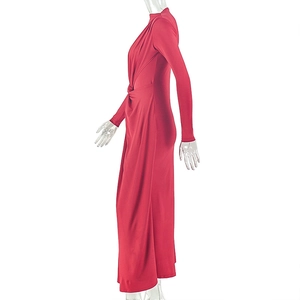 Detail of red slim fit dress showing ruched waist twist and draped fabric texture