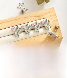Detailed close-up of titanium steel butterfly earring with colorful zircon stones inlay