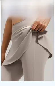 Detail of high-waisted taupe yoga skort leggings with built-in skirt for gym coverage