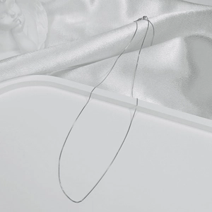 Macro shot of minimalist S925 sterling silver box chain necklace with smooth metal luster