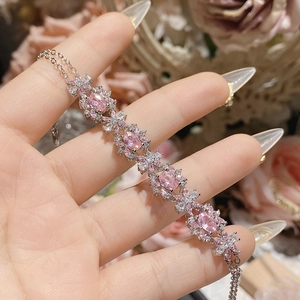 Elegant 18K gold plated bracelet with pink oval zircons and white flower clusters