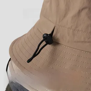 Macro shot of nylon bucket hats with adjustable elastic drawstrings and plastic buckles