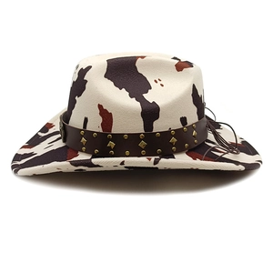 Detail of cow print western hat with faux leather band and gold metal rivets decoration