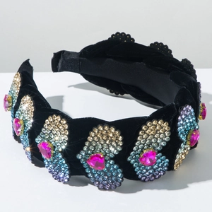 Dettaglio del cerchietto in velluto con strass colorati e cristalli a cuore rosa