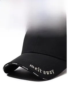 Detailed close-up of embroidered letters on the brim of a black cotton baseball cap