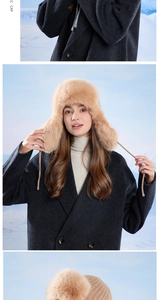 Detail of warm winter ushanka hat with faux fur lining and plush ear flaps in camel color