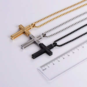 Three stainless steel cross necklaces in gold, silver, and black with spring pendant design