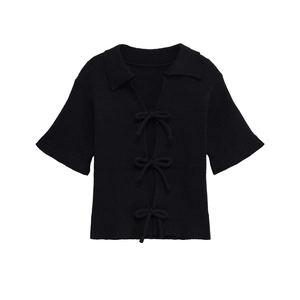 Women's black short sleeve knit cardigan featuring a lapel collar and three bow ties