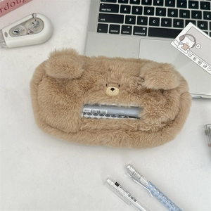 Close-up of cute brown plush bear pencil case with zipper and embroidered details