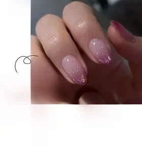 Detail of short almond press-on nails with purple gradient and sparkling glitter finish