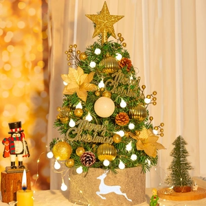 Mini tabletop Christmas tree with gold ornaments, warm LED lights, and burlap reindeer base