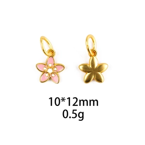 Macro view of gold-plated carnation pendant with pink enamel detail for DIY jewelry