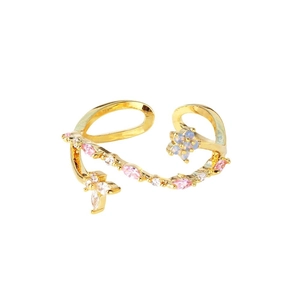 Golden open ring with pink marquise gems and blue accents on white background