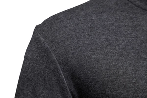 Close-up of dark grey knitted fabric showing shoulder stitching and fine texture