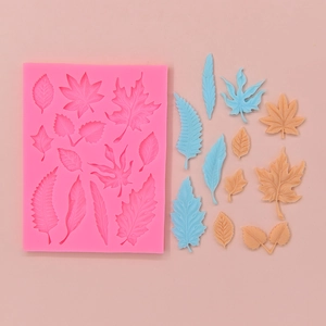 Pink silicone leaf mold for DIY cake decorating with maple and fern leaf shapes