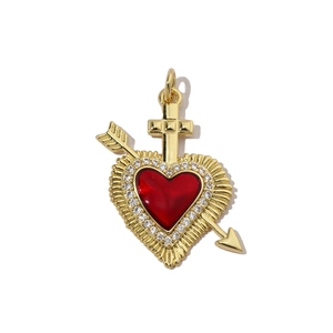 Detail of a red enamel heart pendant with a Cupid arrow and cross set in gold and cubic zirconia