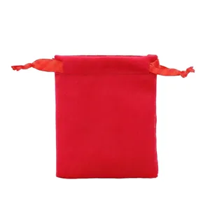 Close-up of red velvet drawstring pouch with silk ribbons for jewelry storage