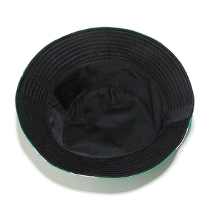 Detail of a black bucket hat showing the inner circular stitching and shamrock print brim