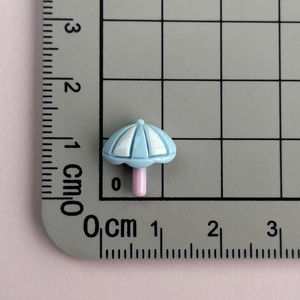 Mini resin beach umbrella accessory showing 2cm height measurement on a scale ruler