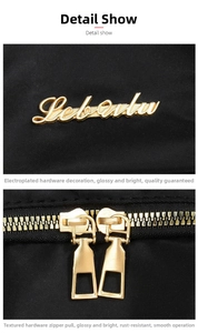 Detail of high-density black nylon backpack with gold-plated metal logo and dual zippers
