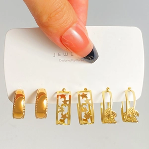 Detailed set of gold geometric earrings including hollow star and leaf patterns