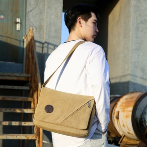 Khaki canvas messenger bag for men with flap cover and shoulder strap on model back view
