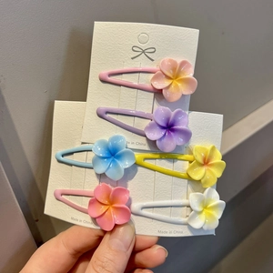 Set of six sweet macaron-colored cherry blossom hair clips for girls on a display card