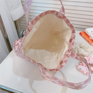 Interior view of pink heart jacquard tote bag showing cream lining and spacious storage