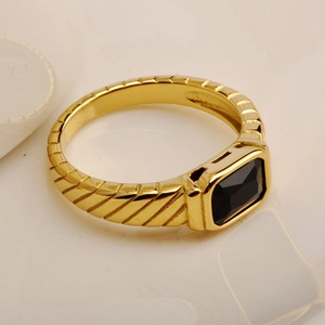 Detail of 18K gold ring with diagonal grooves and a rectangular black onyx stone inlay