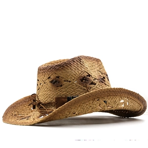 Detail of hollow-out weave pattern and brown leather band on western straw cowboy hat