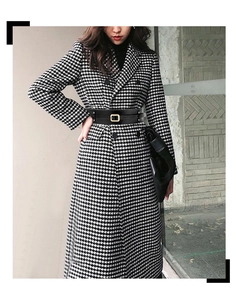 Detail of wide black waist belt with gold square buckle on a houndstooth coat