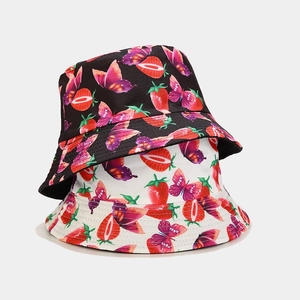 Reversible strawberry and butterfly pattern bucket hats in black and white cotton twill